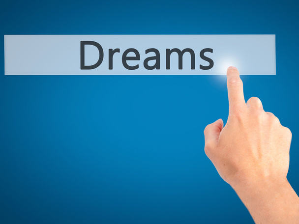 Dreams - Appuyer à la main sur un bouton sur le concept de fond flou sur
 - Photo, image
