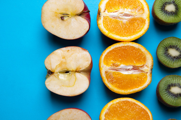 Healthy fruits on a blue background from above - Foto, afbeelding