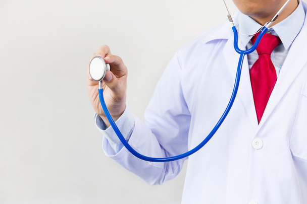 Close-up of male doctor using stethoscope and focusing on stethoscope - Photo, image