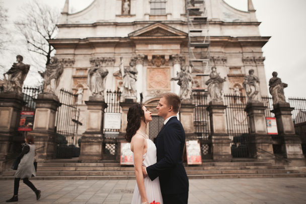 Wedding couple, bride and groom near a church in Krakow - Фото, зображення