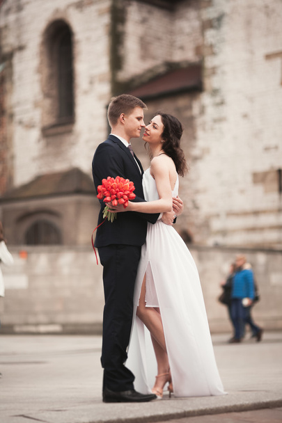 Wedding couple, bride and groom near a church in Krakow - Photo, image