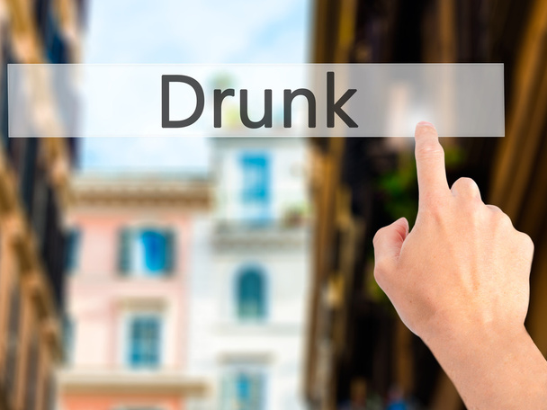 Drunk - Hand pressing a button on blurred background concept on  - Photo, Image