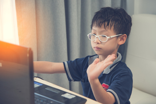 Back to School. Asian boy using his laptop at home - Фото, зображення