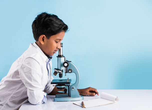 Indyjski chłopiec i mikroskopem, Azjatycki chłopiec z mikroskopem, słodkie małe dziecko gospodarstwa mikroskopem, 10-letni chłopiec indian i eksperyment nauki, eksperymenty robi nauki chłopca - Zdjęcie, obraz