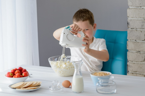 Child mixing with electric mixer white cottage cheese - Zdjęcie, obraz