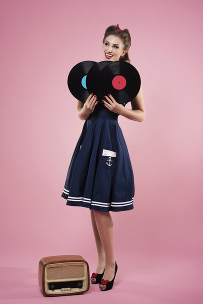 Pin up woman holding vinyl records - Фото, зображення