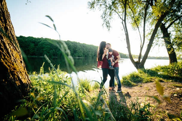 young family with a child on the nature - 写真・画像