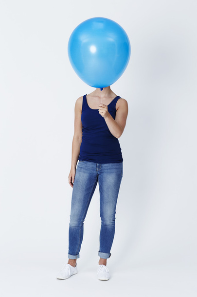 Young woman holding floating balloon - Photo, Image