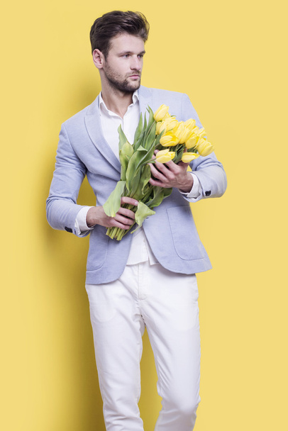 Man holding yellow tulips  - Photo, Image