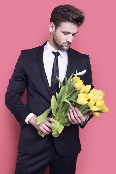 Man holding yellow tulips  - Zdjęcie, obraz