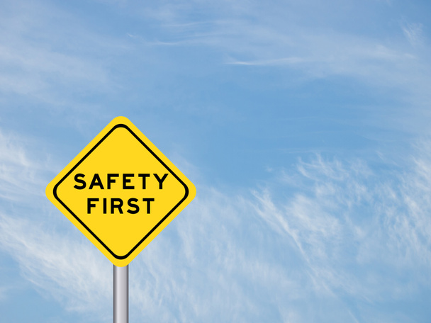 wording "Safety first" on yellow traffic sign on the blue sky  - Photo, Image