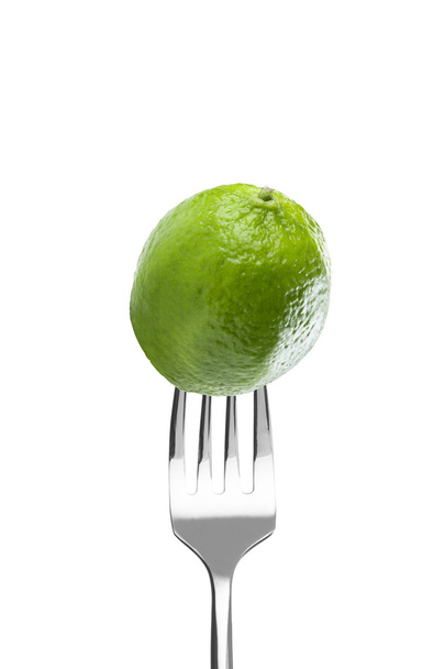 Fresh lime on a fork - Фото, зображення