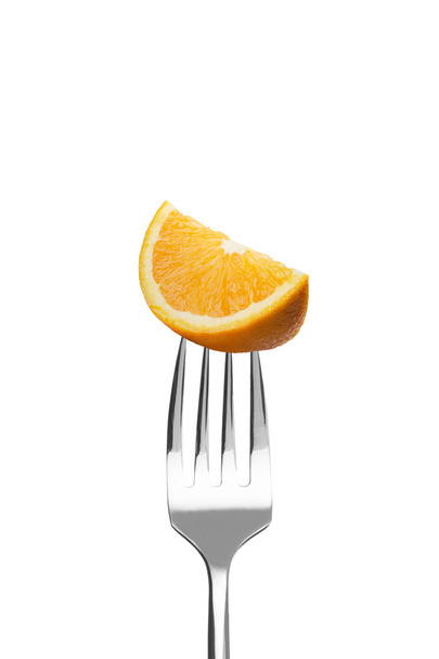 Fresh orange on a fork - Zdjęcie, obraz