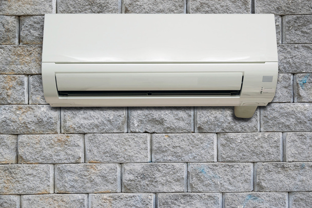 Wall air conditioning hanging on a brick wall. - Photo, Image