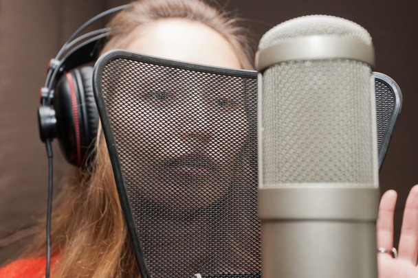 Female singer with headphones recording in studio - Fotografie, Obrázek