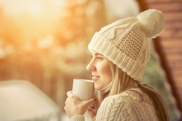 Female with cup of coffee at winter - 写真・画像