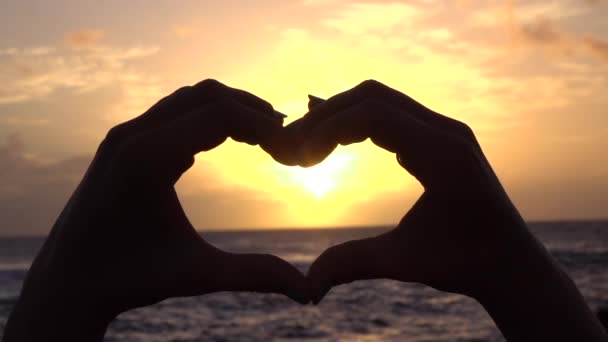 SLOW MOTION: Capturing preety golden sun with heart shaped hands - Footage, Video