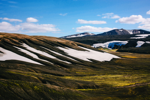 Landscape with moss and snow in Iceland. Mountain tourism - Photo, Image