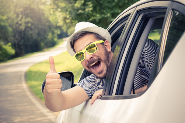 Man in car showing thumbs up - Фото, изображение