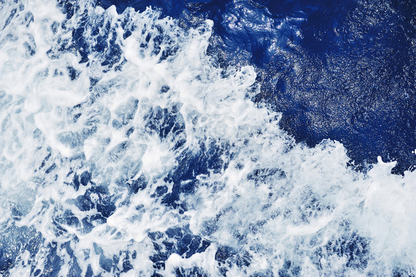 Blue sea water surface in motion with foam - Photo, Image