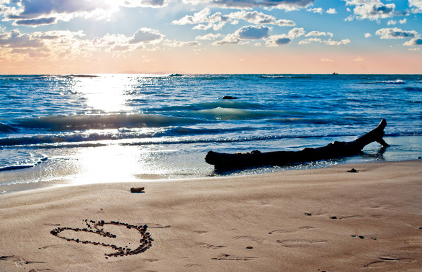 μια καρδιά στην παραλία το ηλιοβασίλεμα - Φωτογραφία, εικόνα