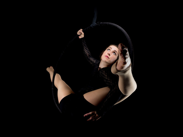 Graceful aerial dancer woman isolated on black - Foto, immagini