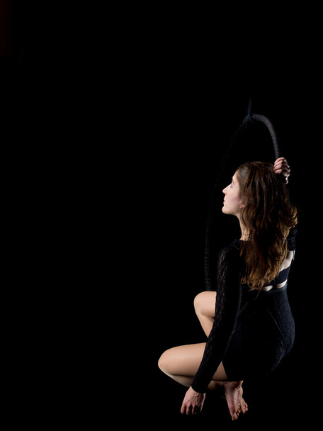 Χαριτωμένη εναέρια χορεύτρια γυναίκα απομονωμένη σε μαύρο - Φωτογραφία, εικόνα