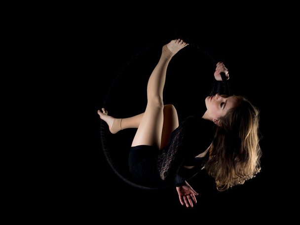 Graceful aerial dancer woman isolated on black - Photo, Image