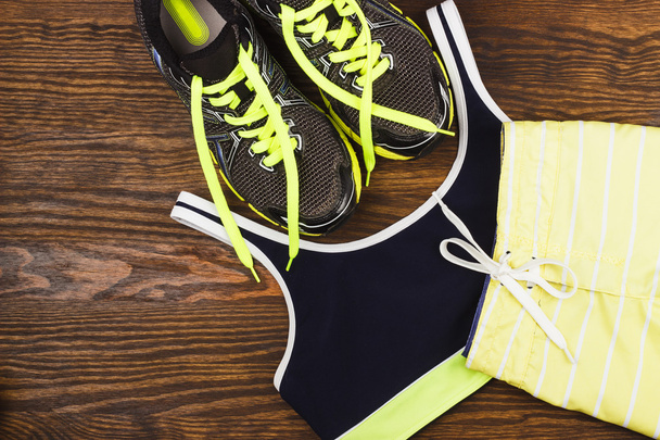 Green sneakers, shorts and sport bra - 写真・画像