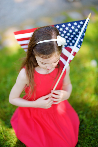 Little girl holding american flag - Foto, imagen