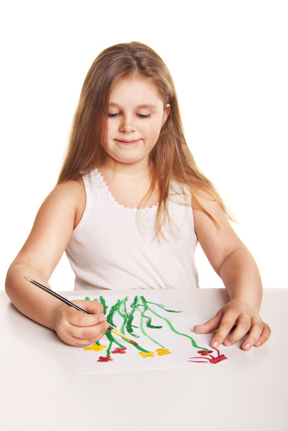Small beautiful girl paints flowers over white - Valokuva, kuva