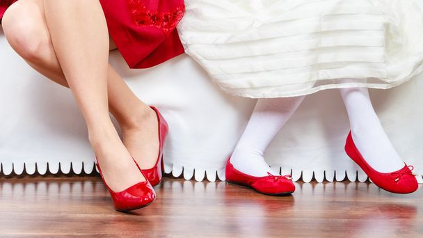 Legs mother and daughter in red shoes - Photo, image