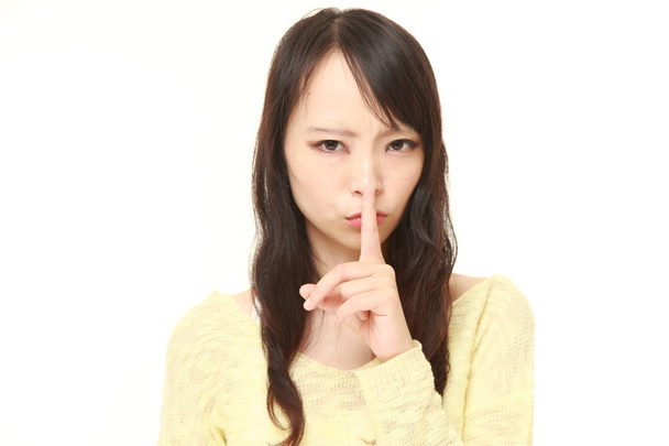 young Japanese woman whith silence gestures - Foto, imagen