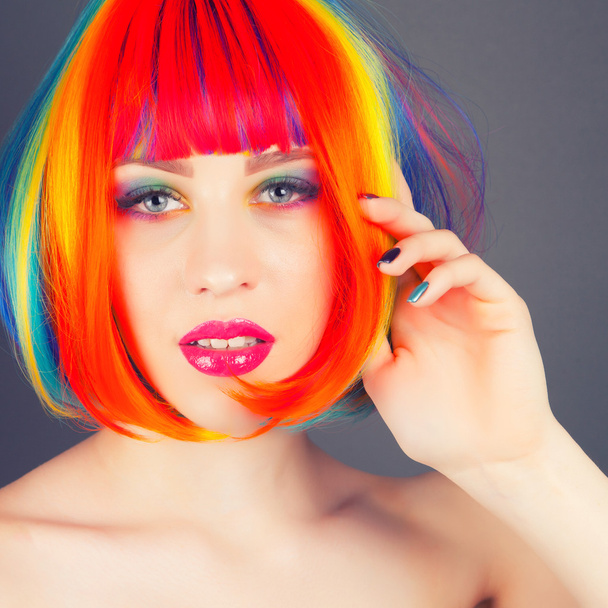 beautiful woman wearing colorful wig - Foto, Imagen