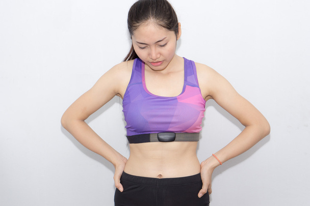 Woman in sport bra and heart rate monitor with tape isolated on  - Foto, afbeelding