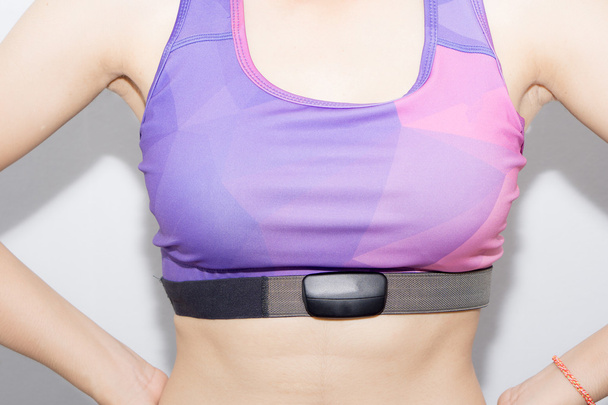 Woman in sport bra and heart rate monitor with tape isolated on  - Φωτογραφία, εικόνα