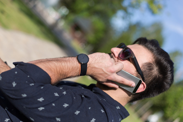 Young bearded man talking on smartphone  - Фото, зображення
