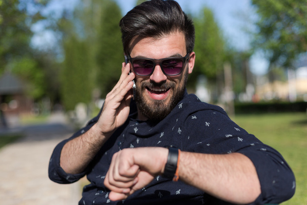 Young bearded man talking on smartphone  - Φωτογραφία, εικόνα