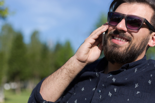 Young bearded man talking on smartphone  - Zdjęcie, obraz
