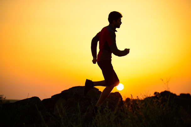 Young Sportsman Running on the Rocky Mountain Trail at Sunset. Active Lifestyle - Photo, Image