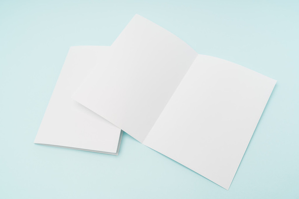 Bifold white template paper on blue background . - Photo, Image