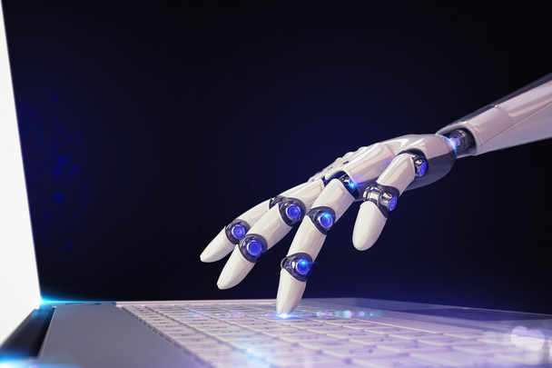 δάχτυλο ενός ρομπότ αγγίζει ένα φορητό πληκτρολόγιο - Φωτογραφία, εικόνα