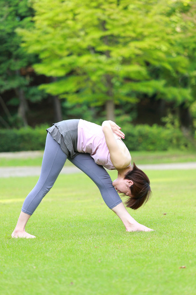 Japanese woman outside doing yoga  - Foto, afbeelding