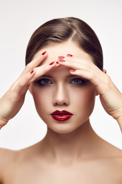 Red lips girl touching forehead - Φωτογραφία, εικόνα