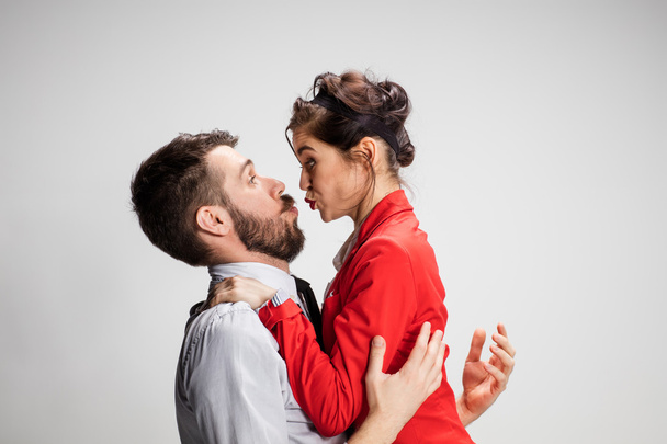 The business man and woman communicating on a gray background - Valokuva, kuva