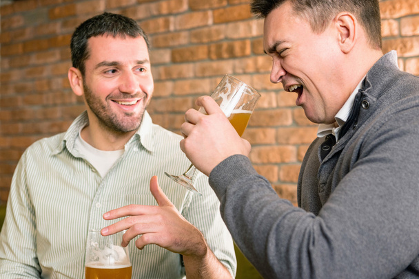 colleagues drinking beer after work - Photo, Image