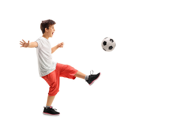 Excited boy playing football  - Фото, зображення