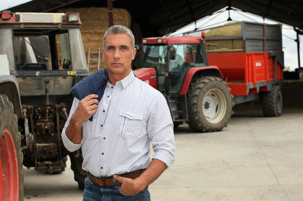 Farmer stood in front of tractors - Φωτογραφία, εικόνα