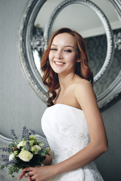 Portrait of the beautiful bride against a window indoors - Foto, afbeelding