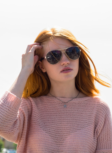 Red-haired girl is in sunglasses - Valokuva, kuva